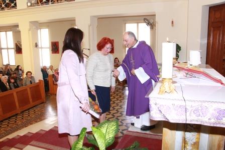 red haired woman approaching calmly the bishop of the church
